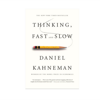 Thinking, Fast and Slow by Daniel Kahneman, white paperback cover with a worn yellow pencil