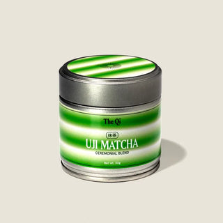 The Qi Uji Ceremonial Matcha in a green and white striped tin, ceremonial blend, net weight 30 g